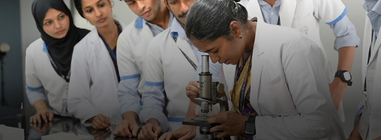 Nursing students examining a sample under a microscope